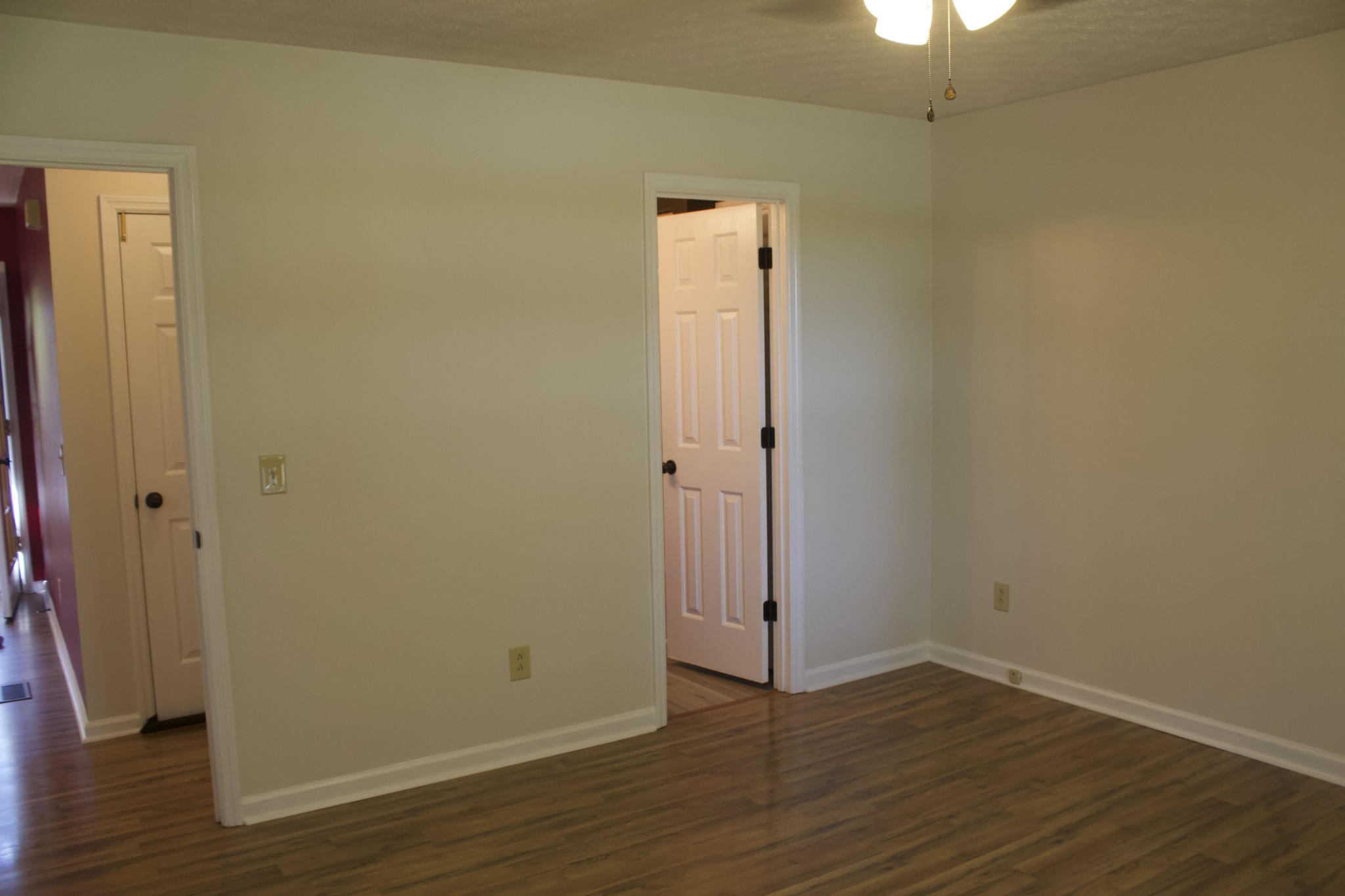 247 Patterson Road Lafayette, TN 37083 - Photo 8 of 37 an empty room with wooden floor and a ceiling fan