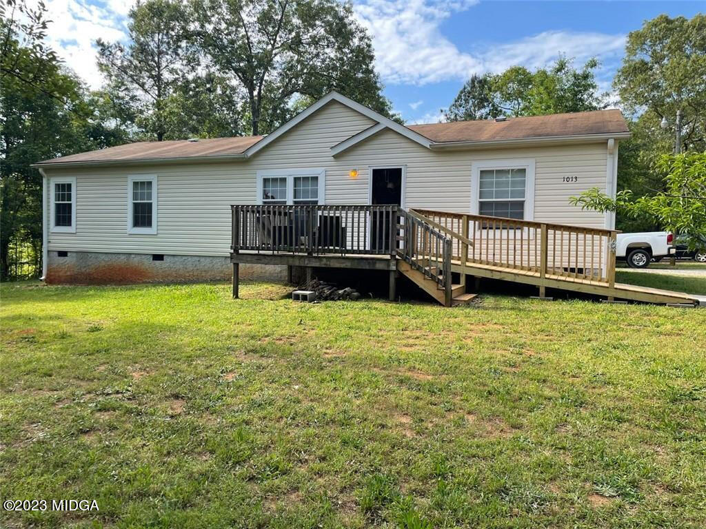 1013 Highway 41 Barnesville, GA 30204 - Photo 1 of 13 a view of a house with a yard and deck