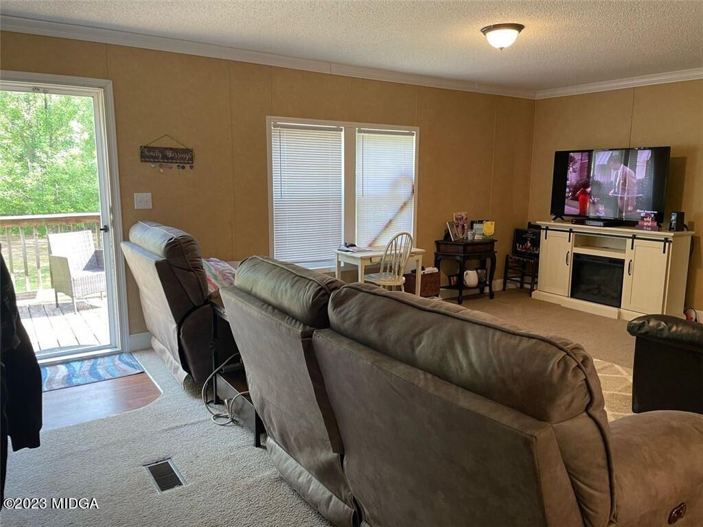 1013 Highway 41 Barnesville, GA 30204 - Photo 3 of 13 a living room with furniture and a flat screen tv