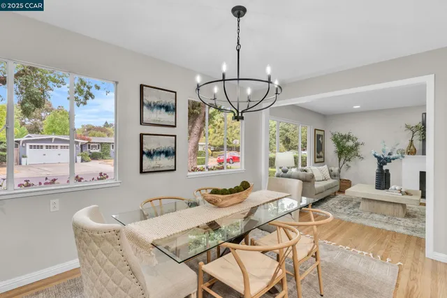 a dining room with furniture a chandelier and window