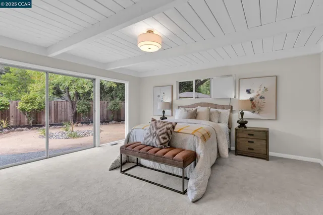 a spacious bedroom with a bed and large window