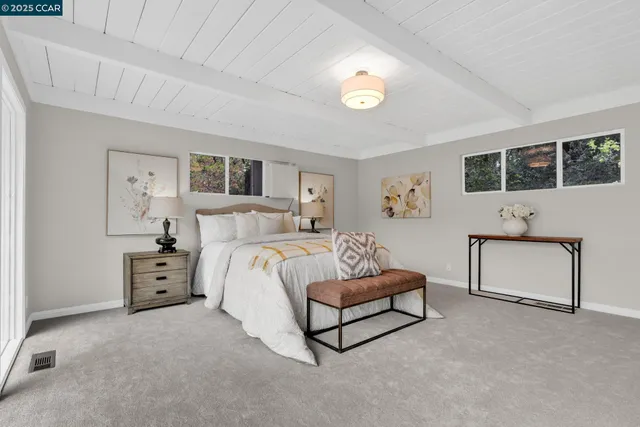 a spacious bedroom with a bed and a couch