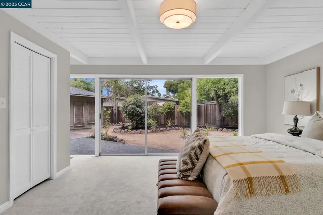 a bedroom with a bed and glass window
