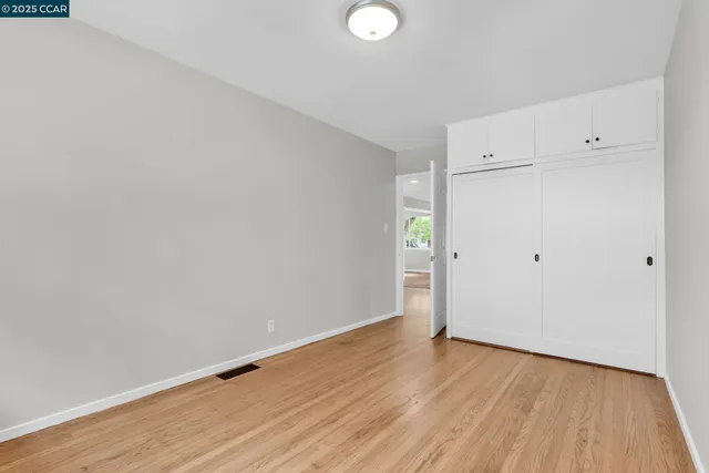 a view of a room with wooden floor