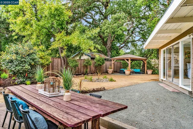 a view of a house with backyard and sitting area