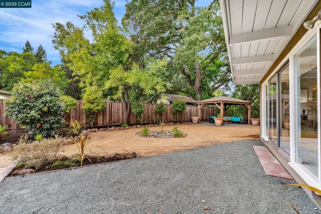 a view of a house with backyard and sitting area