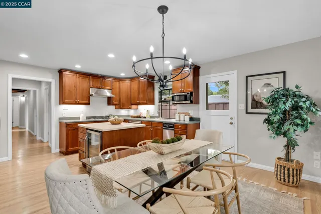 a living room with kitchen island furniture and a chandelier