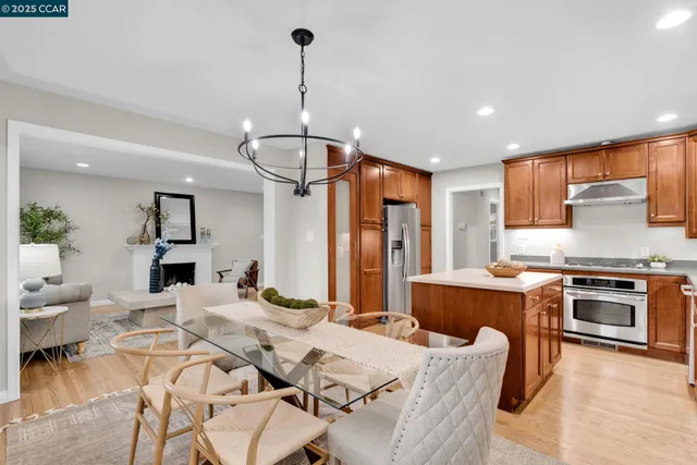 a open kitchen with stainless steel appliances granite countertop a stove and refrigerator