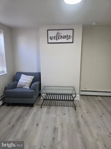 a view of a livingroom with furniture and wooden floor