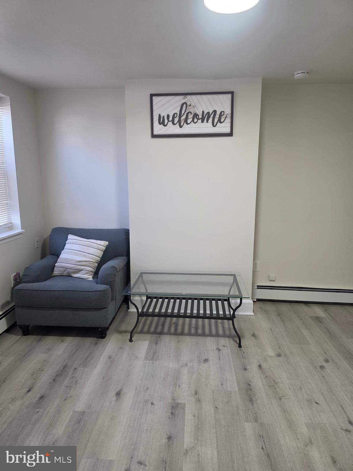 480 West South Street, Unit 1 Frederick, MD 21701 - Photo 11 of 17 a view of a livingroom with furniture and wooden floor