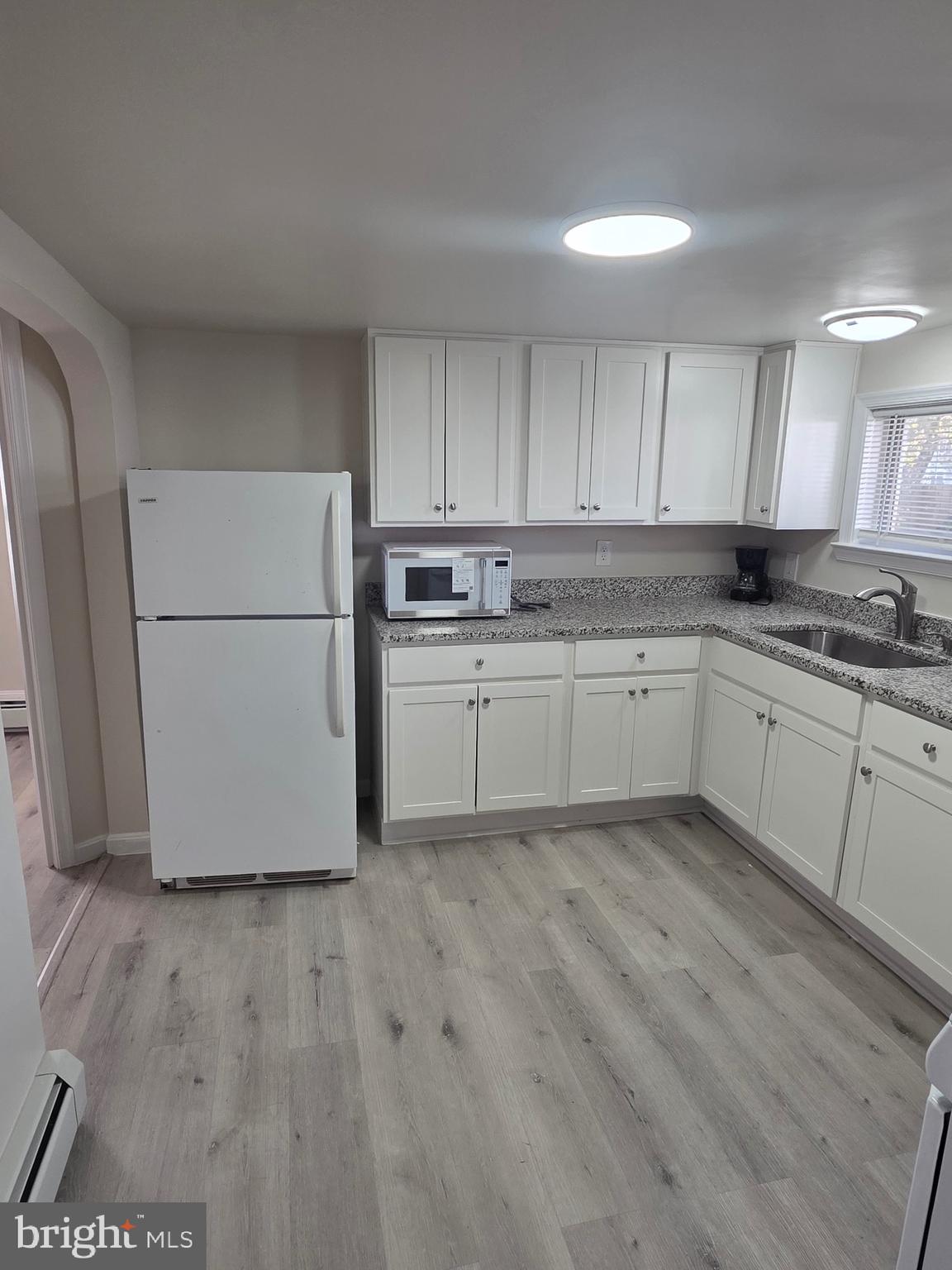 480 West South Street, Unit 1 Frederick, MD 21701 - Photo 17 of 17 a kitchen with a sink a stove a refrigerator and white cabinets