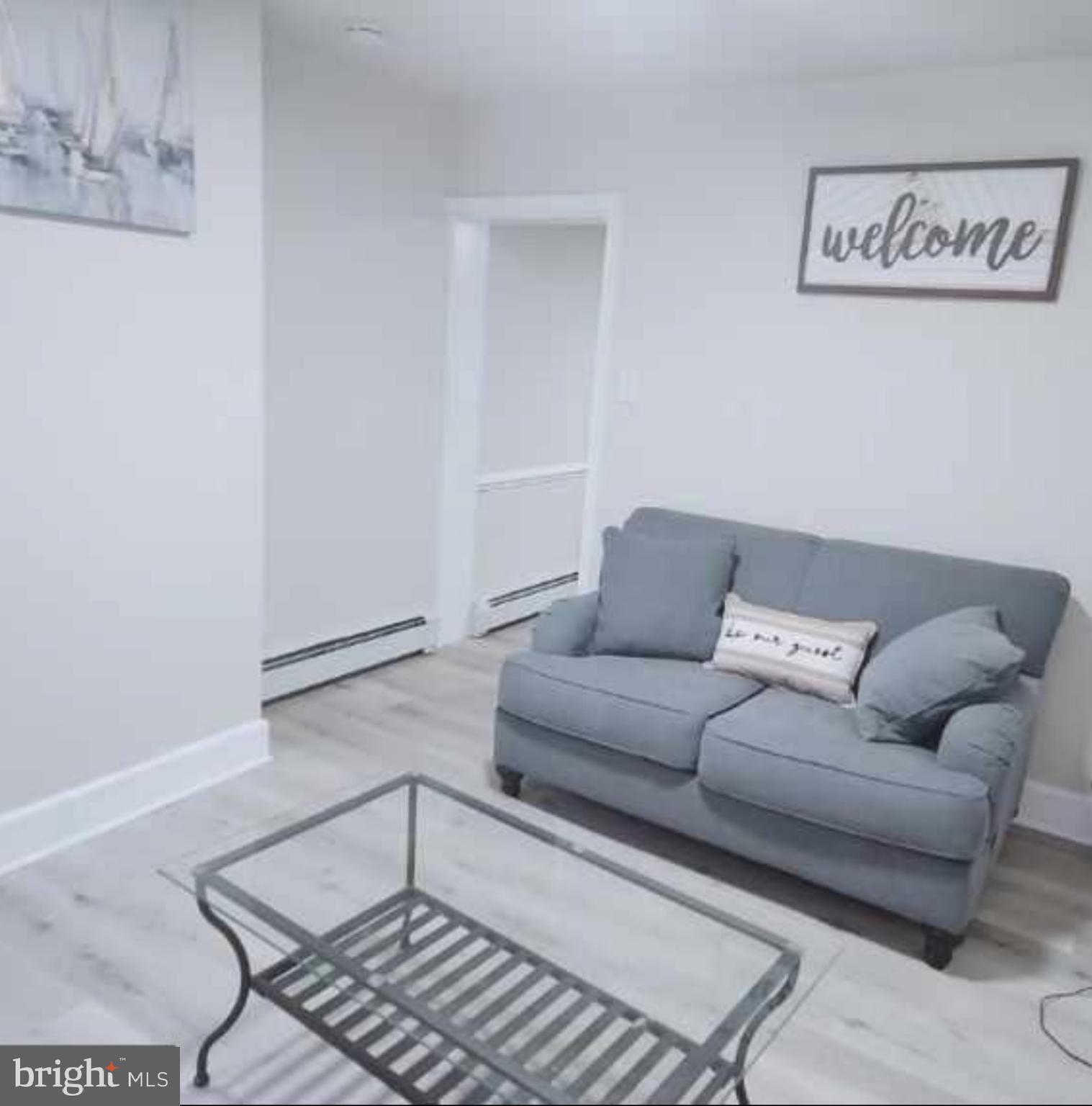 480 West South Street, Unit 1 Frederick, MD 21701 - Photo 3 of 17 a living room with furniture and a rug
