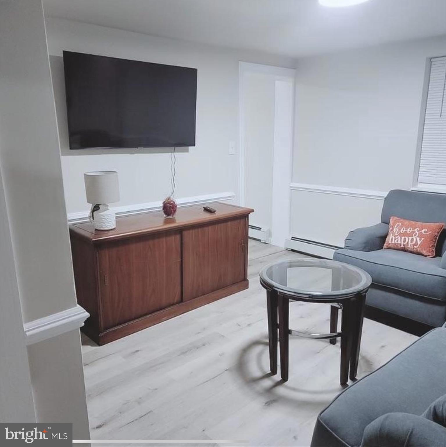 480 West South Street, Unit 1 Frederick, MD 21701 - Photo 4 of 17 a living room with furniture and a flat screen tv