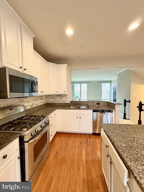 3542 Sprigg Street South Frederick, MD 21704 - Photo 11 of 34 a kitchen with stainless steel appliances granite countertop wooden cabinets a stove top oven a sink and dishwasher