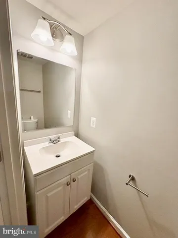 a bathroom with a sink vanity and a mirror