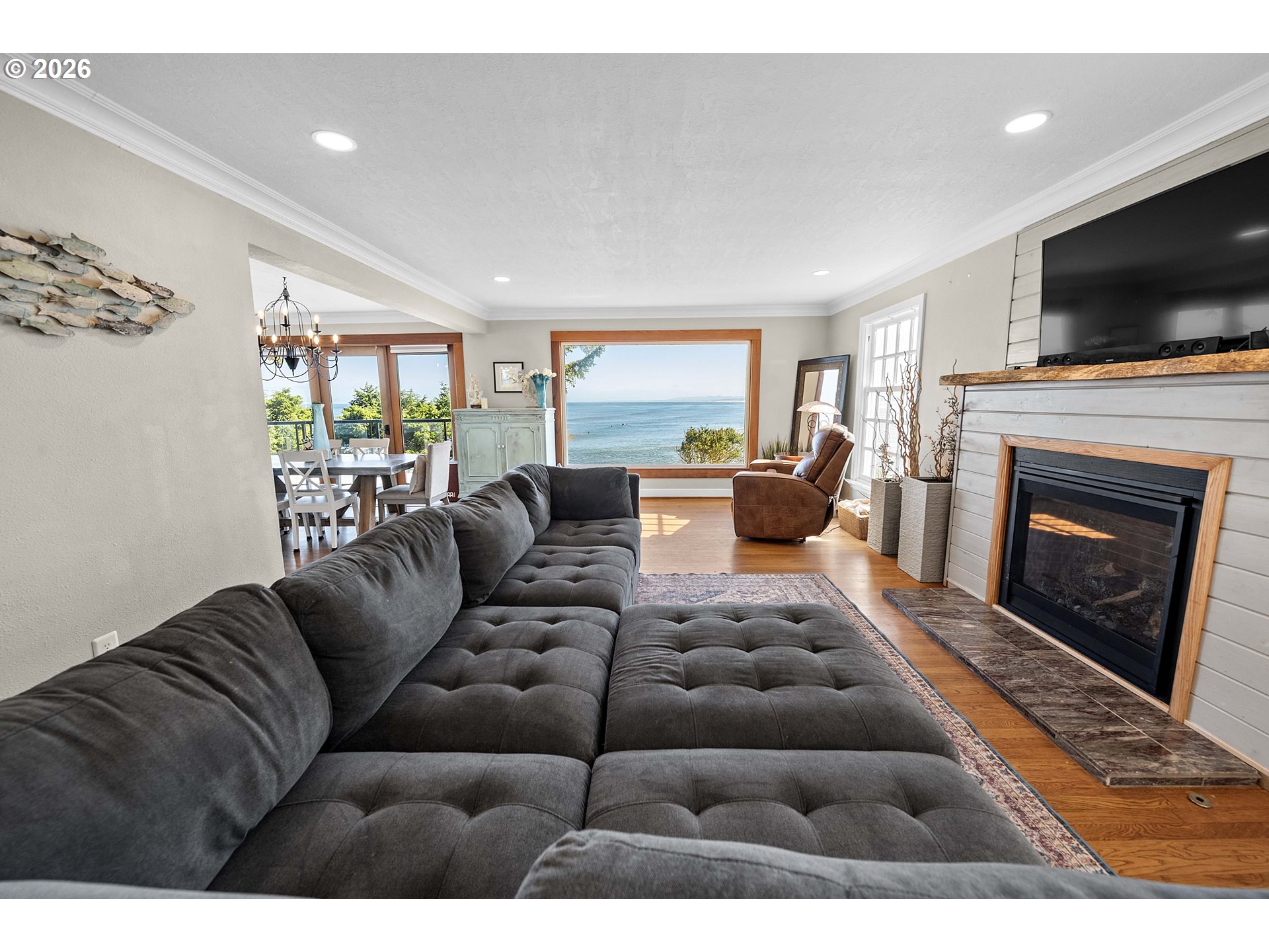 3232 Sunset Boulevard Seaside, OR 97138 - Photo 4 of 48 a living room with furniture a flat screen tv and a fireplace