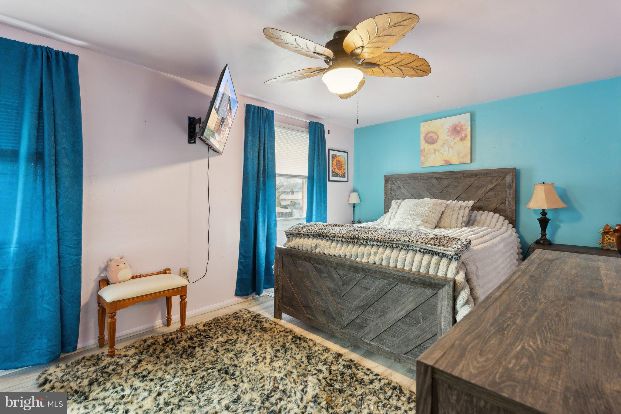 175 Seagull Drive Pasadena, MD 21122 - Photo 13 of 23 a bedroom with a bed and a chandelier