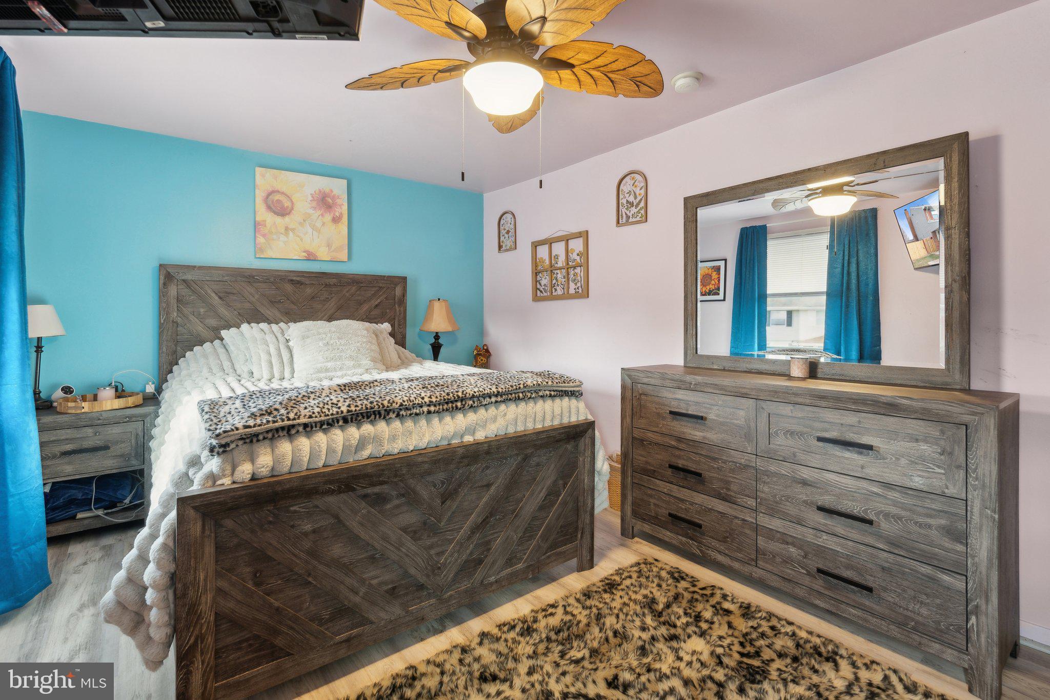 175 Seagull Drive Pasadena, MD 21122 - Photo 14 of 23 a bedroom with a bed and a chandelier