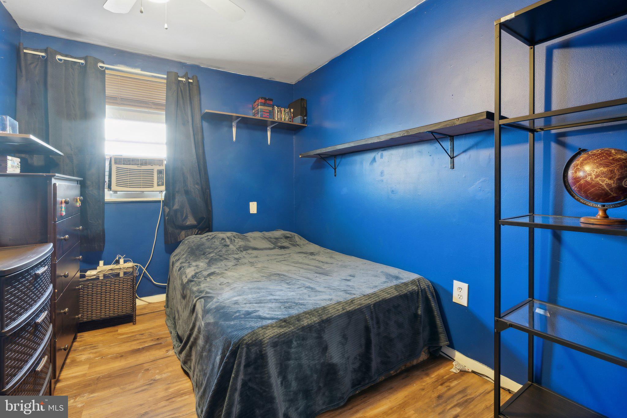 175 Seagull Drive Pasadena, MD 21122 - Photo 15 of 23 a bed sitting in a bedroom next to a window