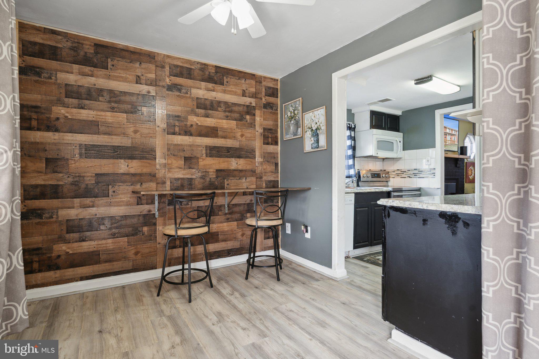 175 Seagull Drive Pasadena, MD 21122 - Photo 2 of 23 a kitchen with a sink cabinets and wooden floor
