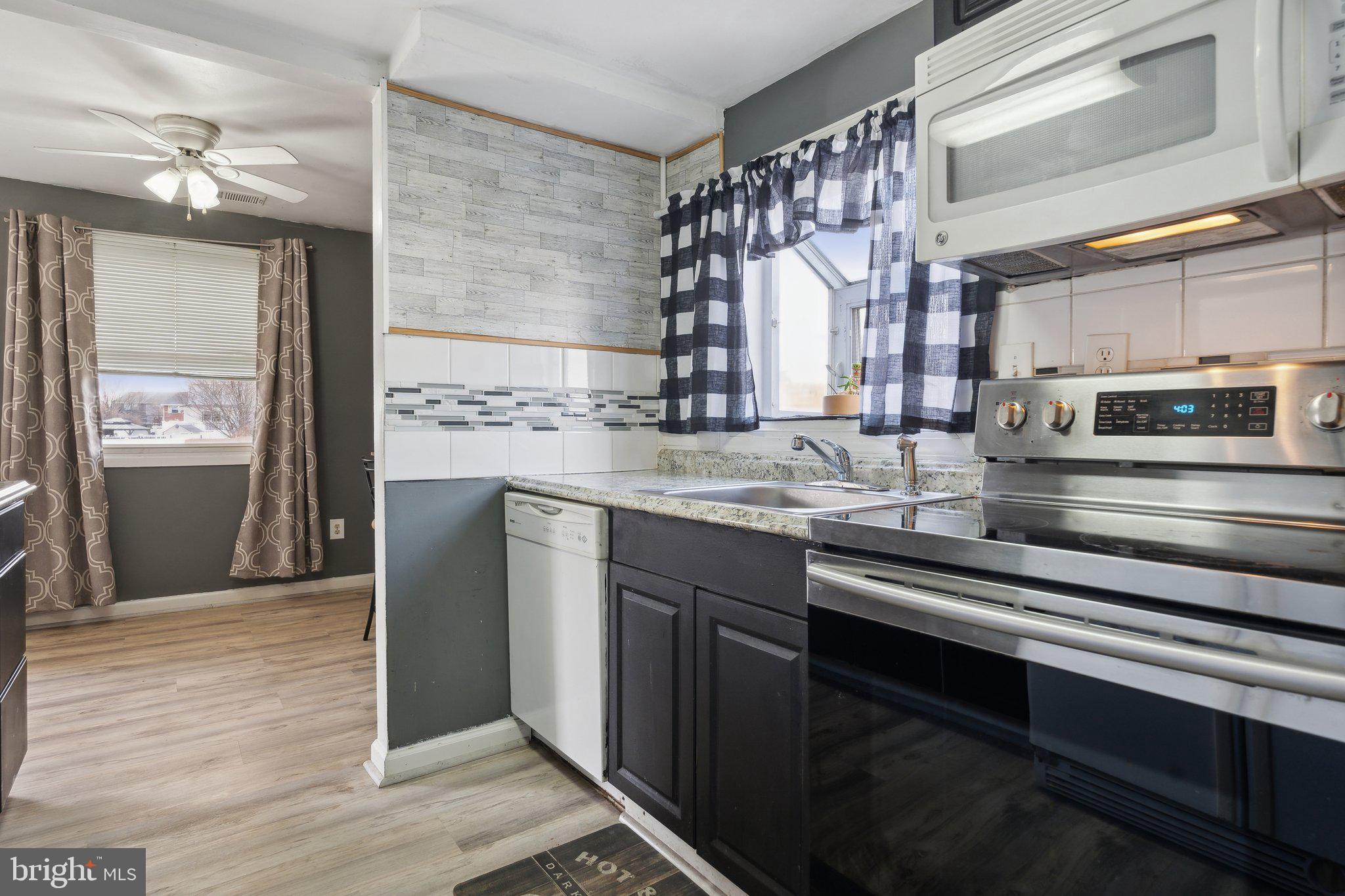 175 Seagull Drive Pasadena, MD 21122 - Photo 5 of 23 a kitchen with stainless steel appliances granite countertop a stove and a sink