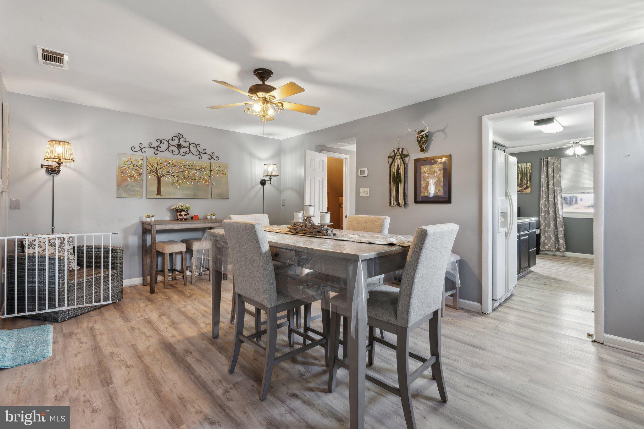 175 Seagull Drive Pasadena, MD 21122 - Photo 6 of 23 a view of a dining room with furniture and wooden floor