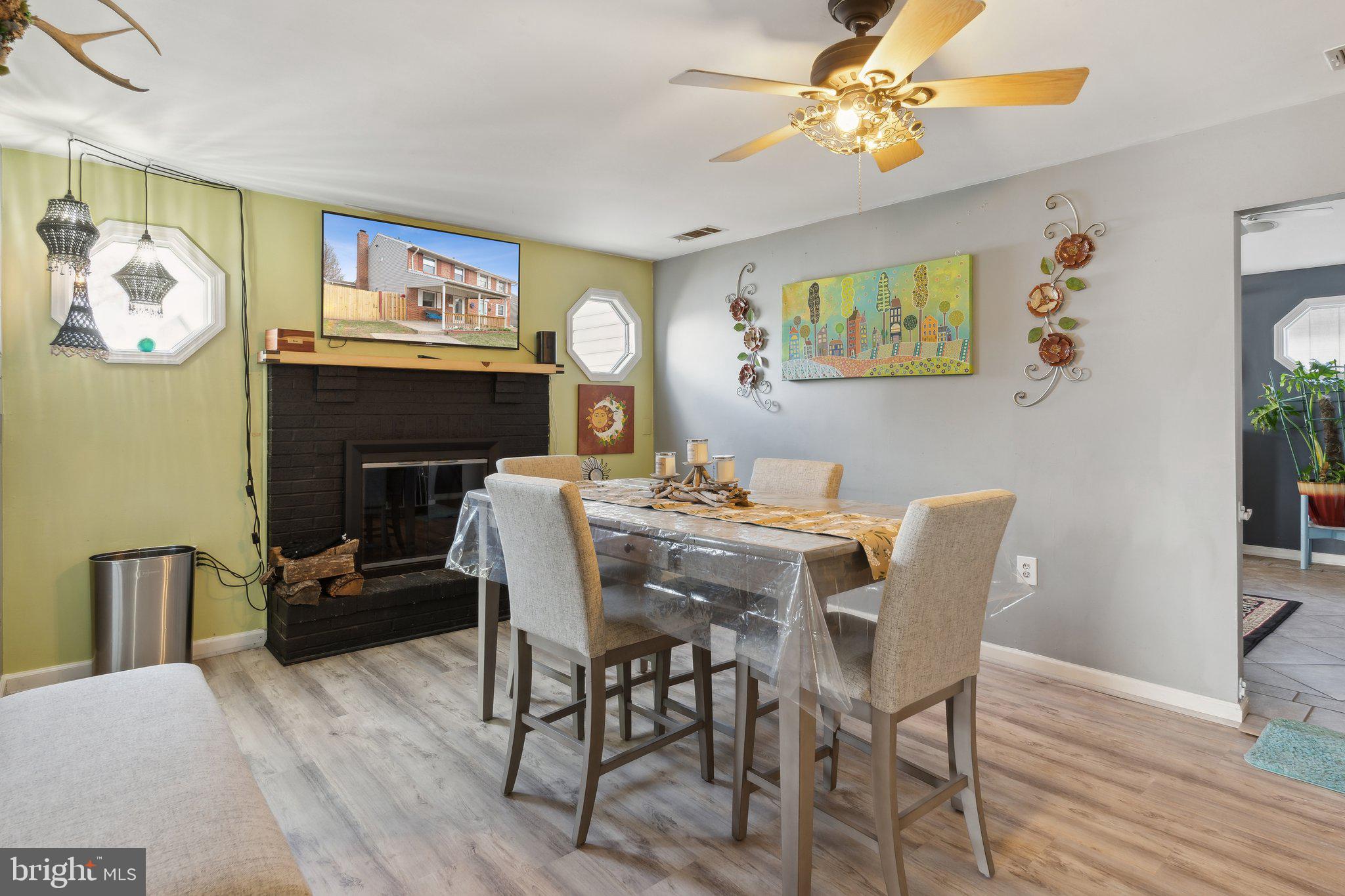 175 Seagull Drive Pasadena, MD 21122 - Photo 7 of 23 a dining room with furniture a chandelier and wooden floor