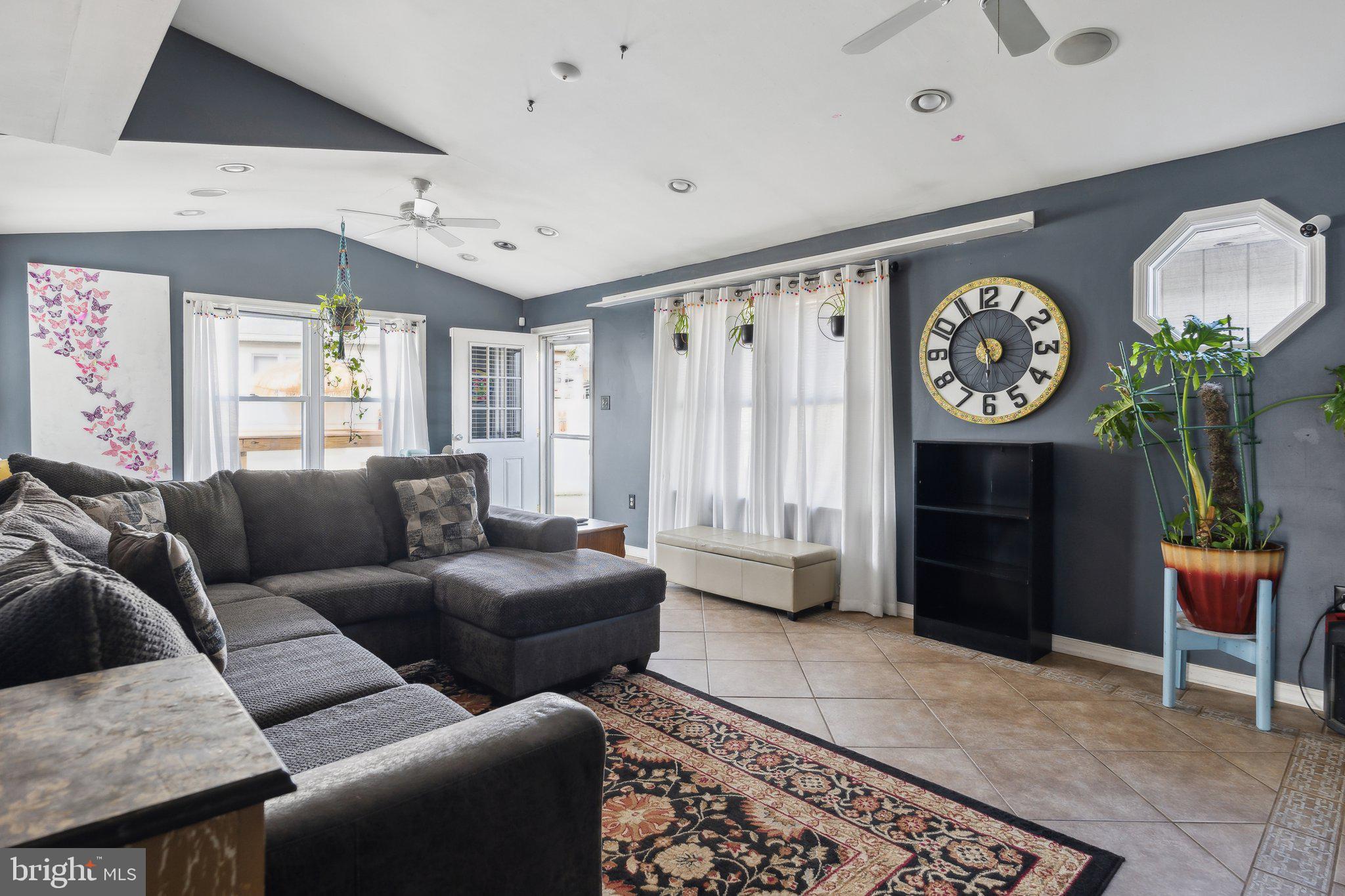 175 Seagull Drive Pasadena, MD 21122 - Photo 10 of 23 a living room with furniture a clock and a window