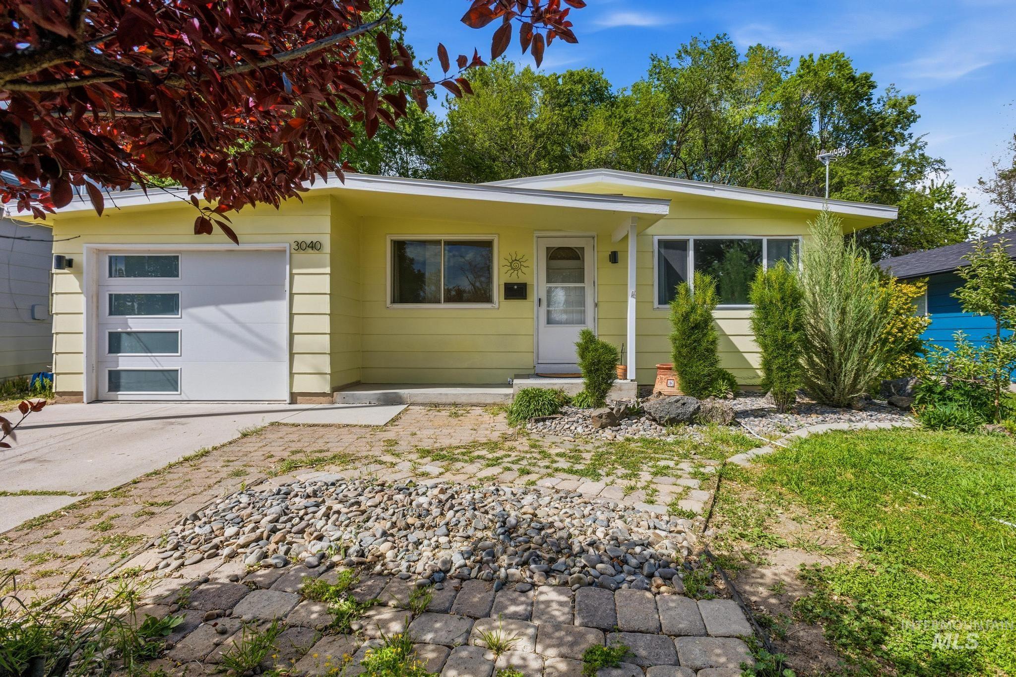 3040 West Hester Street Boise, ID 83702 - Photo 1 of 20 Contemporary single-story residence with light-yellow siding and a white front door