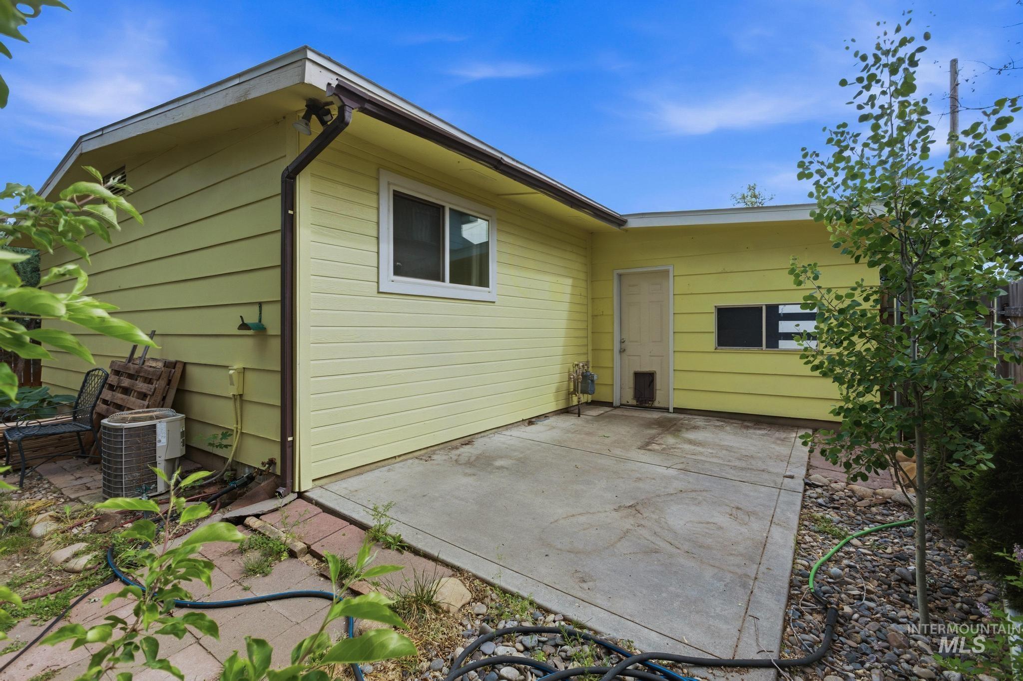 3040 West Hester Street Boise, ID 83702 - Photo 17 of 20 Exterior patio with a concrete surface, bordered by landscaping with river rock and plantings