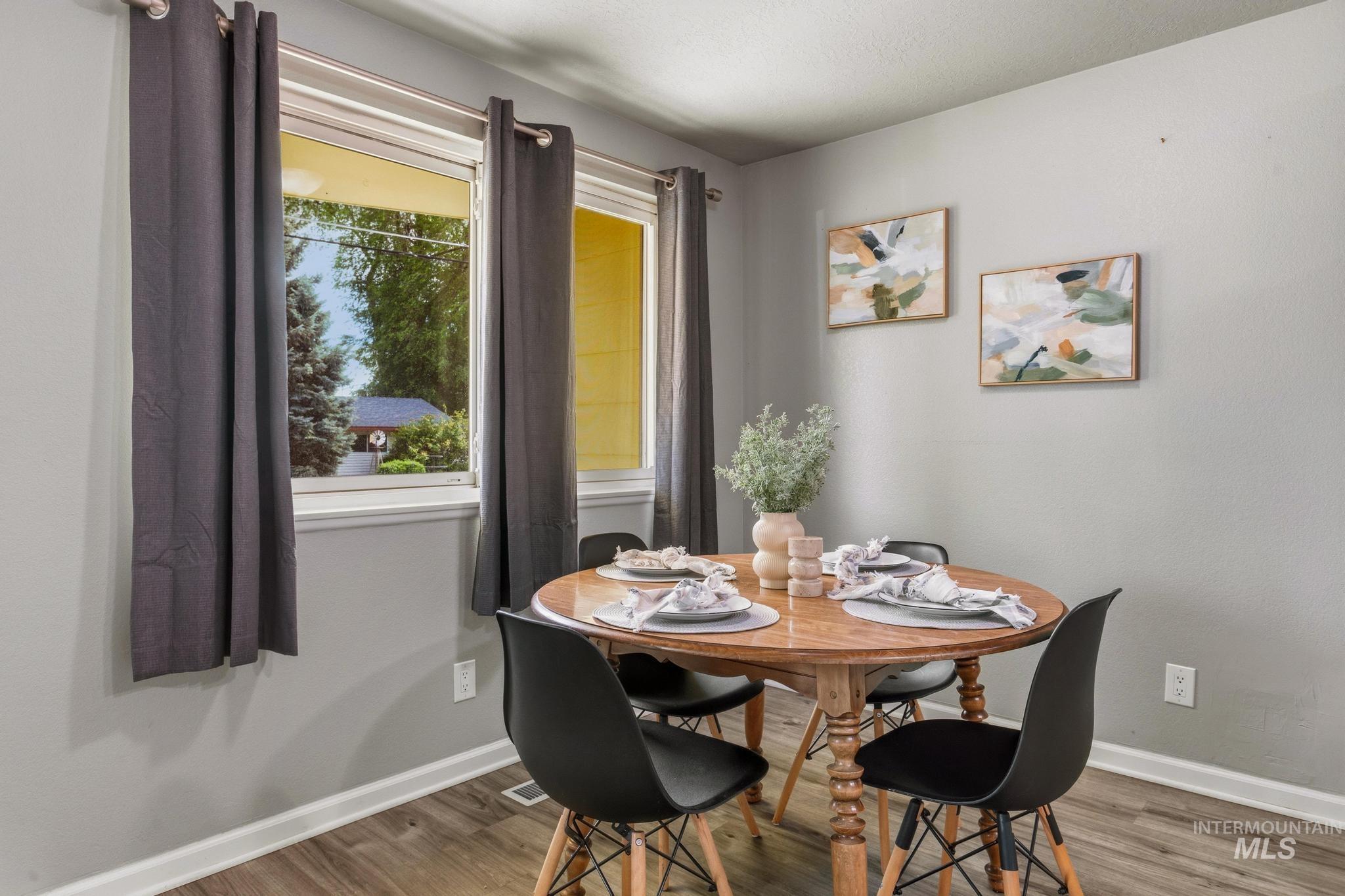3040 West Hester Street Boise, ID 83702 - Photo 8 of 20 Dining area featuring light gray walls, wood-finish flooring, and white trim
