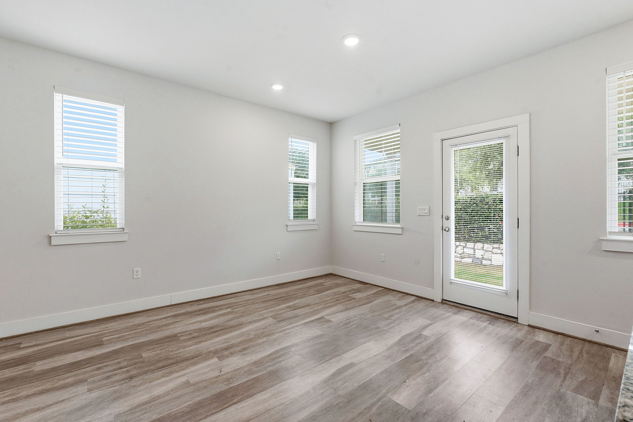 7105 Silver Star Lane, Unit 59 Austin, TX 78744 - Photo 5 of 19 a view of an empty room with wooden floor and a window