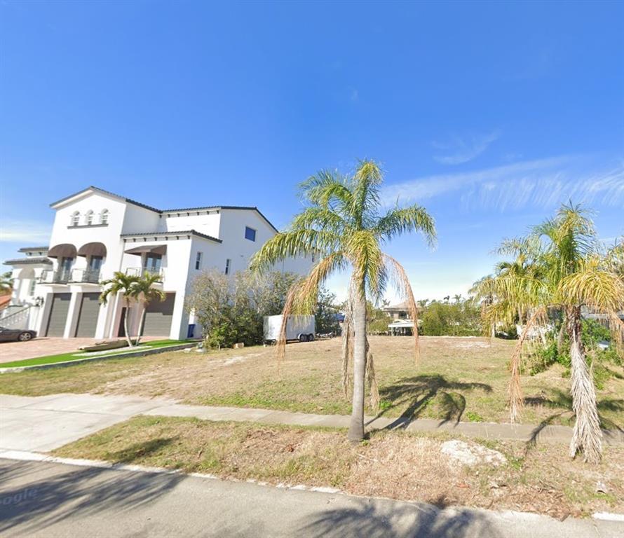 6508 Black Fin Way Apollo Beach, FL 33572 - Photo 2 of 19 a view of a palm trees in front of a building