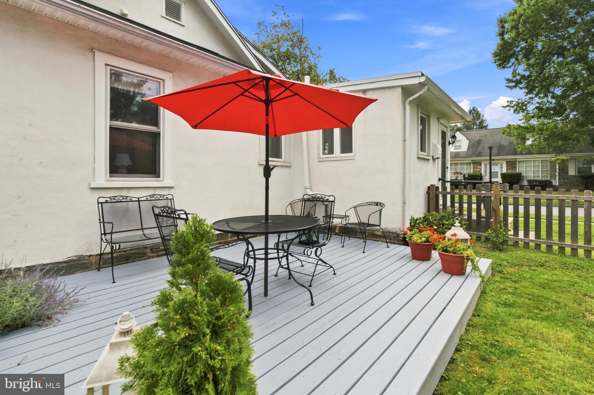 145 Kathmere Road Havertown, PA 19083 - Photo 43 of 49 Charming patio with vibrant red umbrella.