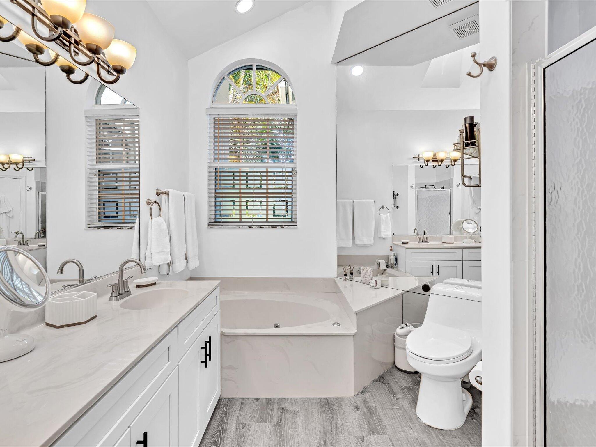 2486 Northwest 66th Drive Boca Raton, FL 33496 - Photo 18 of 80 a bathroom with a granite countertop toilet a sink and a mirror