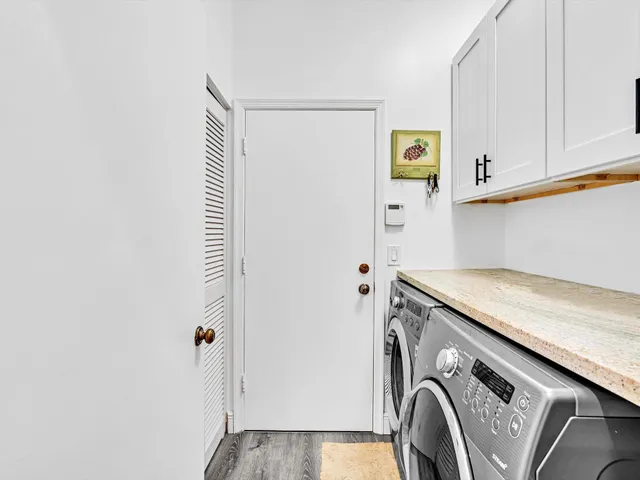 a kitchen with a table chairs sink and cabinets
