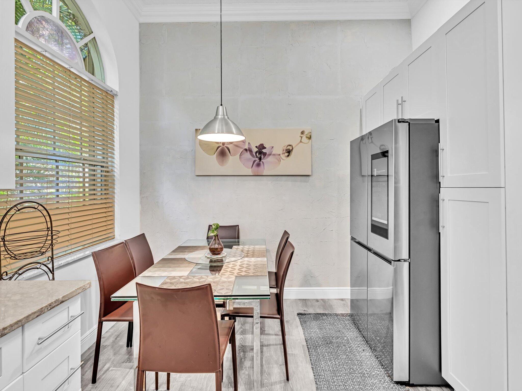 2486 Northwest 66th Drive Boca Raton, FL 33496 - Photo 32 of 80 a view of a dining room with furniture window and wooden floor