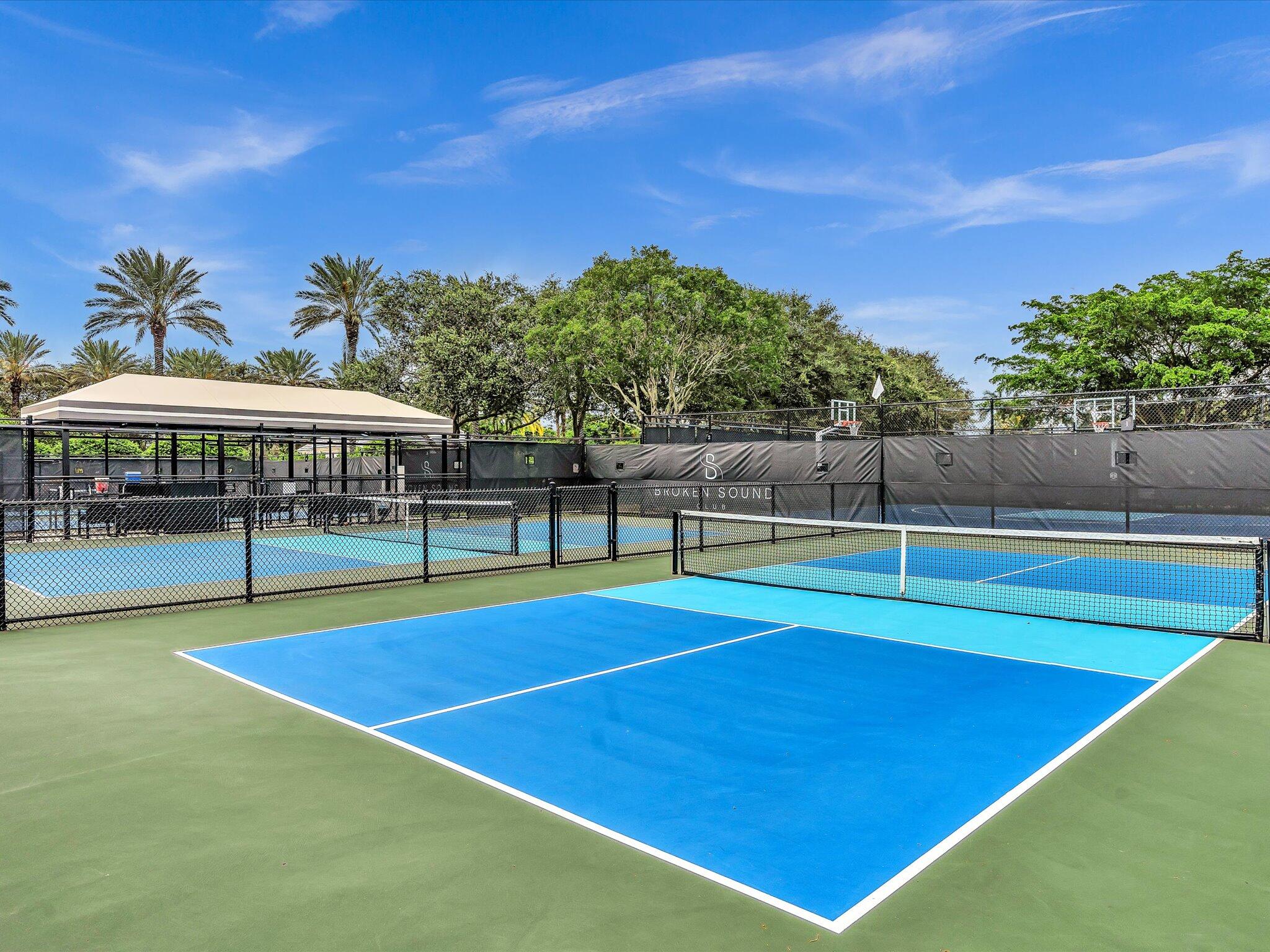 2486 Northwest 66th Drive Boca Raton, FL 33496 - Photo 52 of 80 a view of tennis court with a swimming pool and sitting area