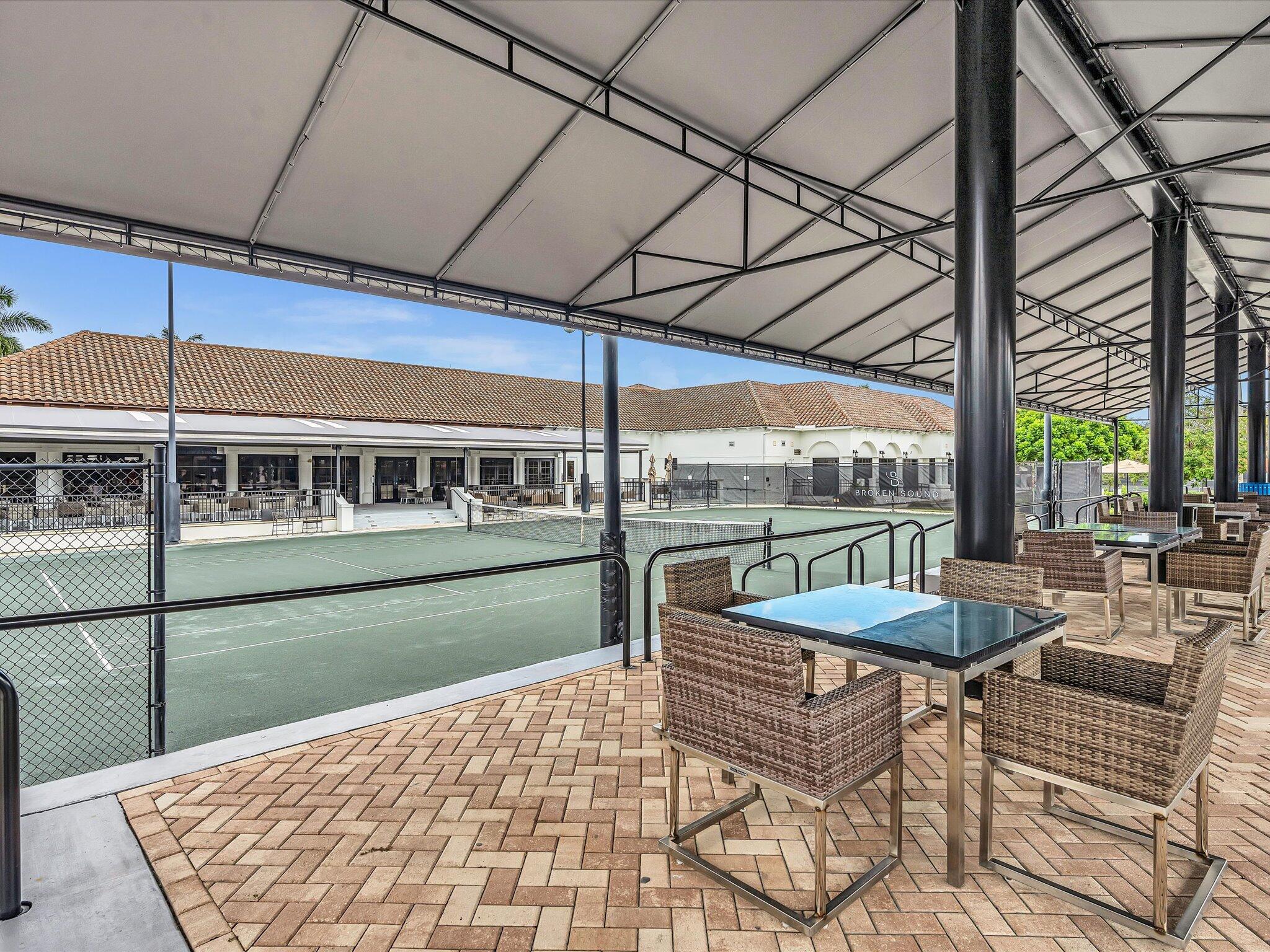 2486 Northwest 66th Drive Boca Raton, FL 33496 - Photo 54 of 80 a view of a patio with a table chairs and wooden floor