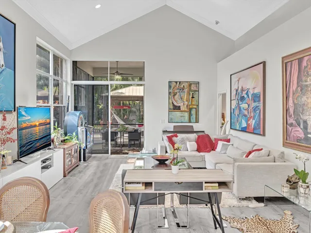 a view of a dining room with furniture a rug and wooden floor