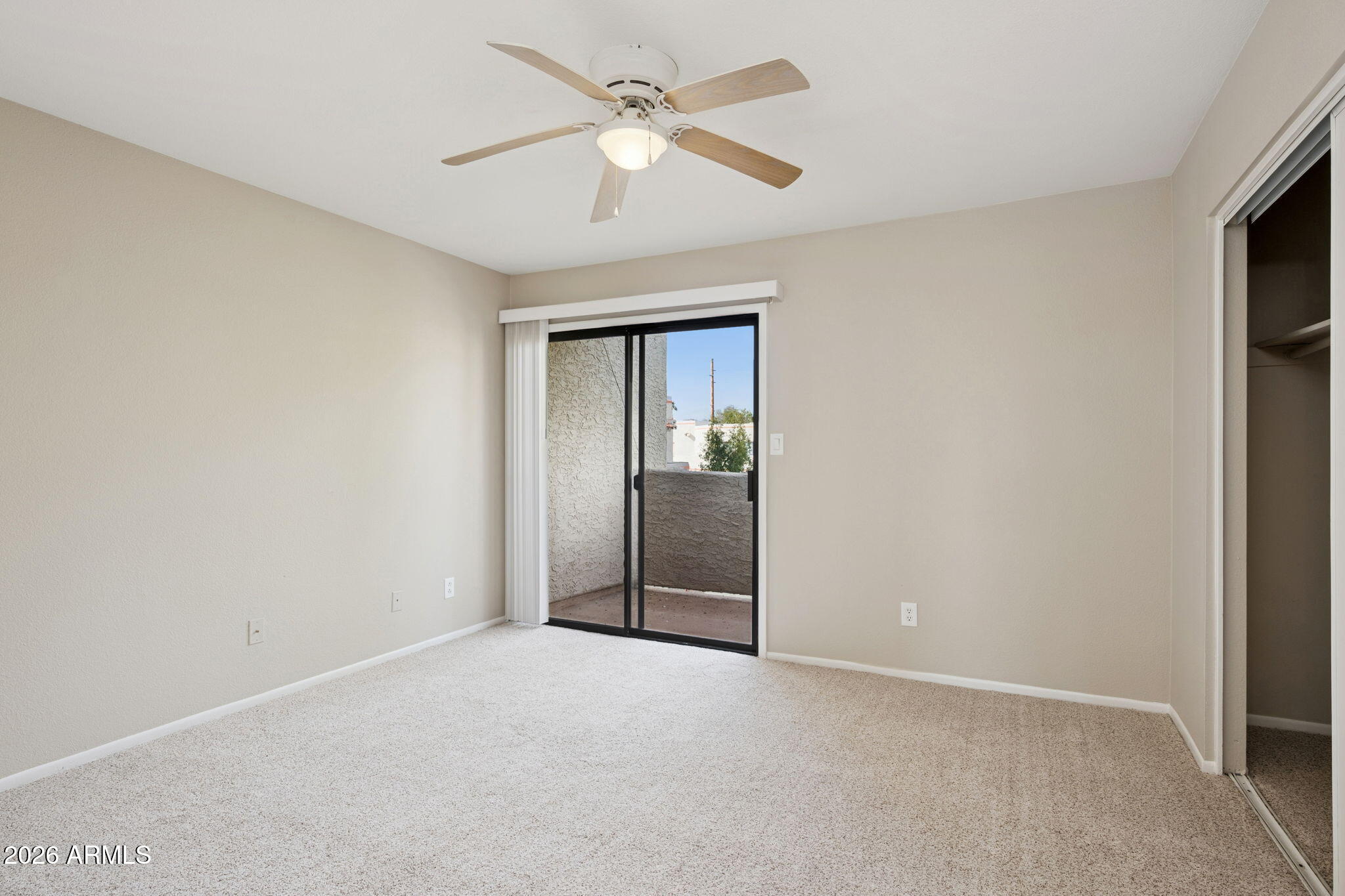 935 North Granite Reef Road, Unit 89 Scottsdale, AZ 85257 - Photo 12 of 32 an empty room with fan and windows