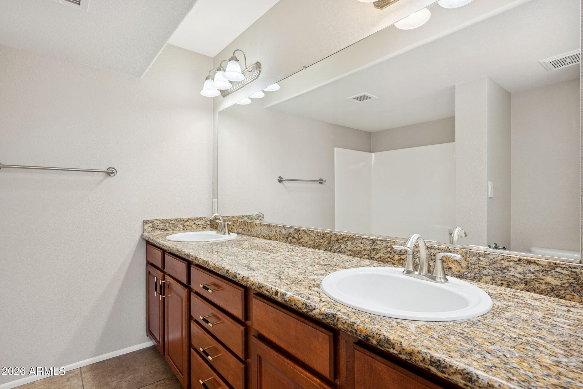 935 North Granite Reef Road, Unit 89 Scottsdale, AZ 85257 - Photo 15 of 32 a bathroom with a granite countertop sink a light fixture and a mirror