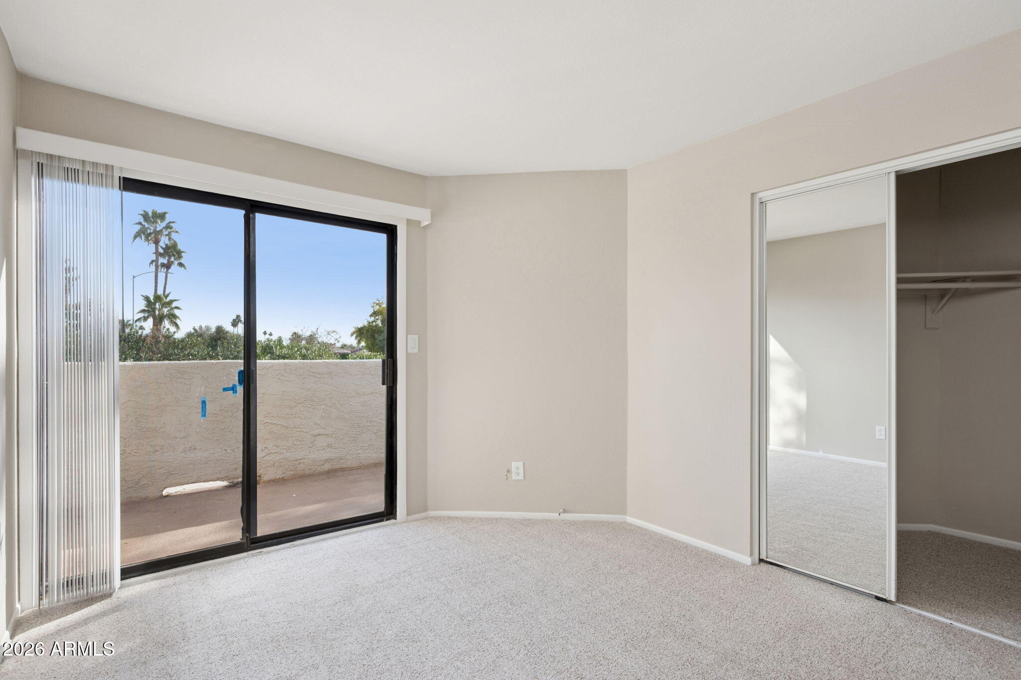 935 North Granite Reef Road, Unit 89 Scottsdale, AZ 85257 - Photo 18 of 32 an empty room with sliding glass door and glass door
