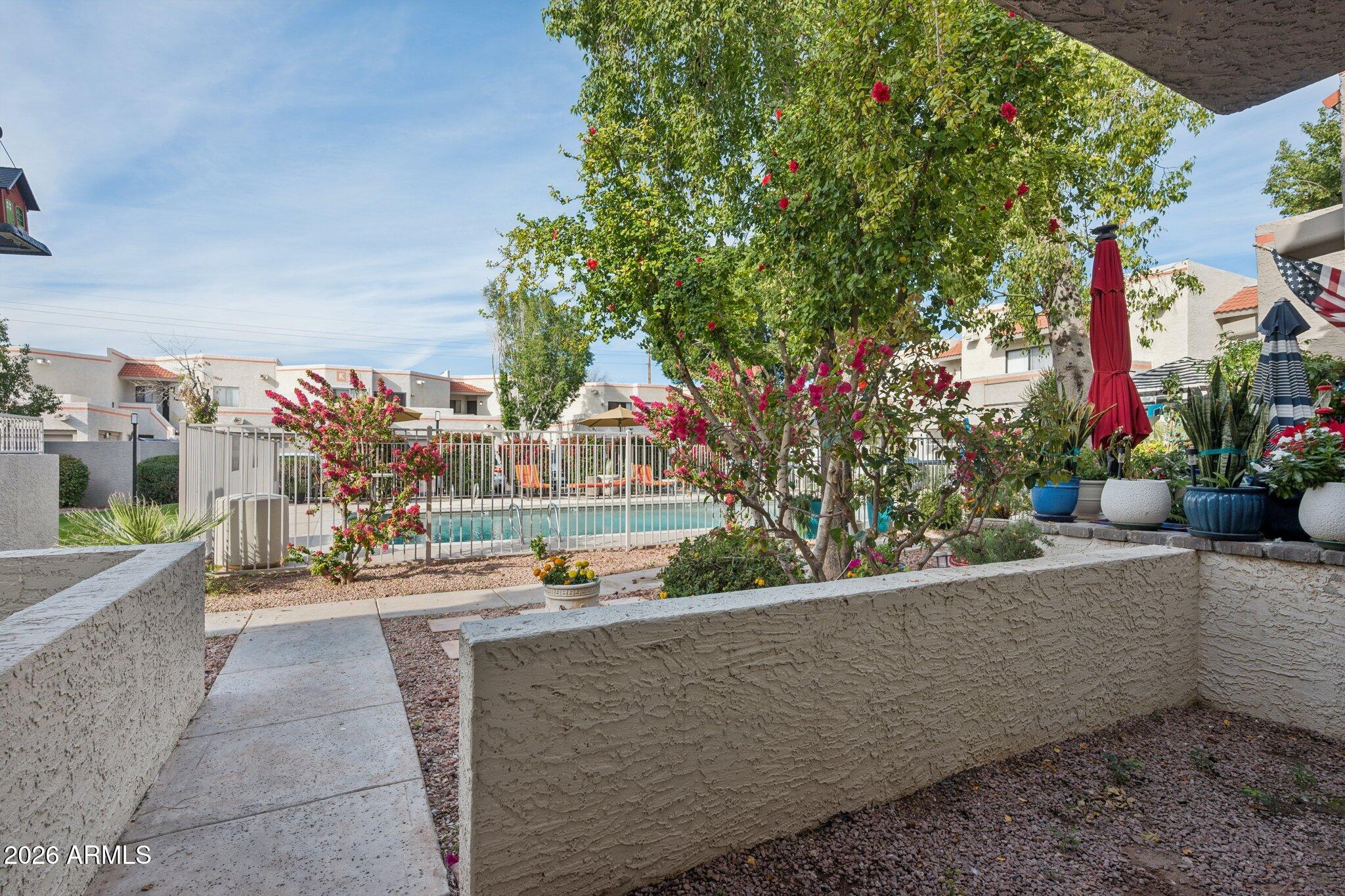 935 North Granite Reef Road, Unit 89 Scottsdale, AZ 85257 - Photo 25 of 32 a view of swimming pool with outdoor seating and a potted plant