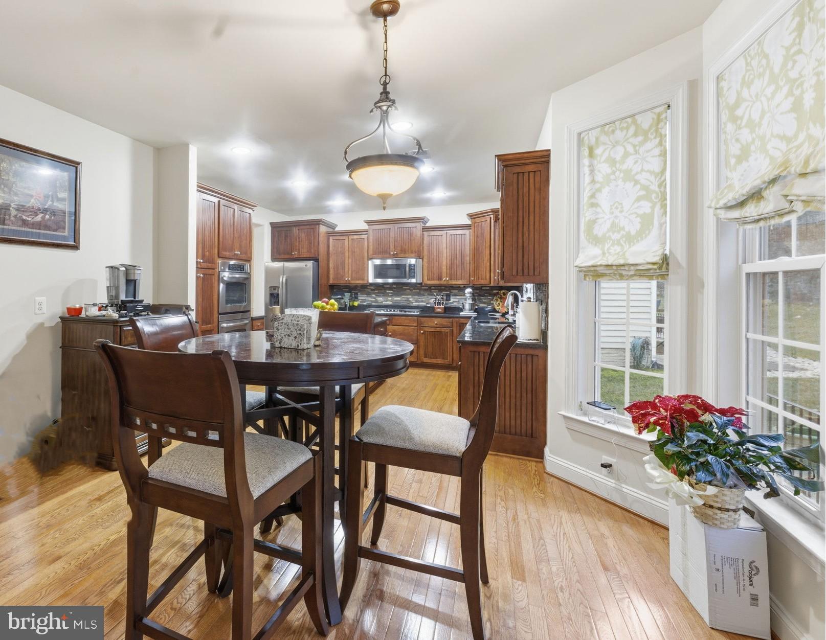 7669 Oak Field Court Springfield, VA 22153 - Photo 12 of 57 a view of a dining room with furniture window and wooden floor