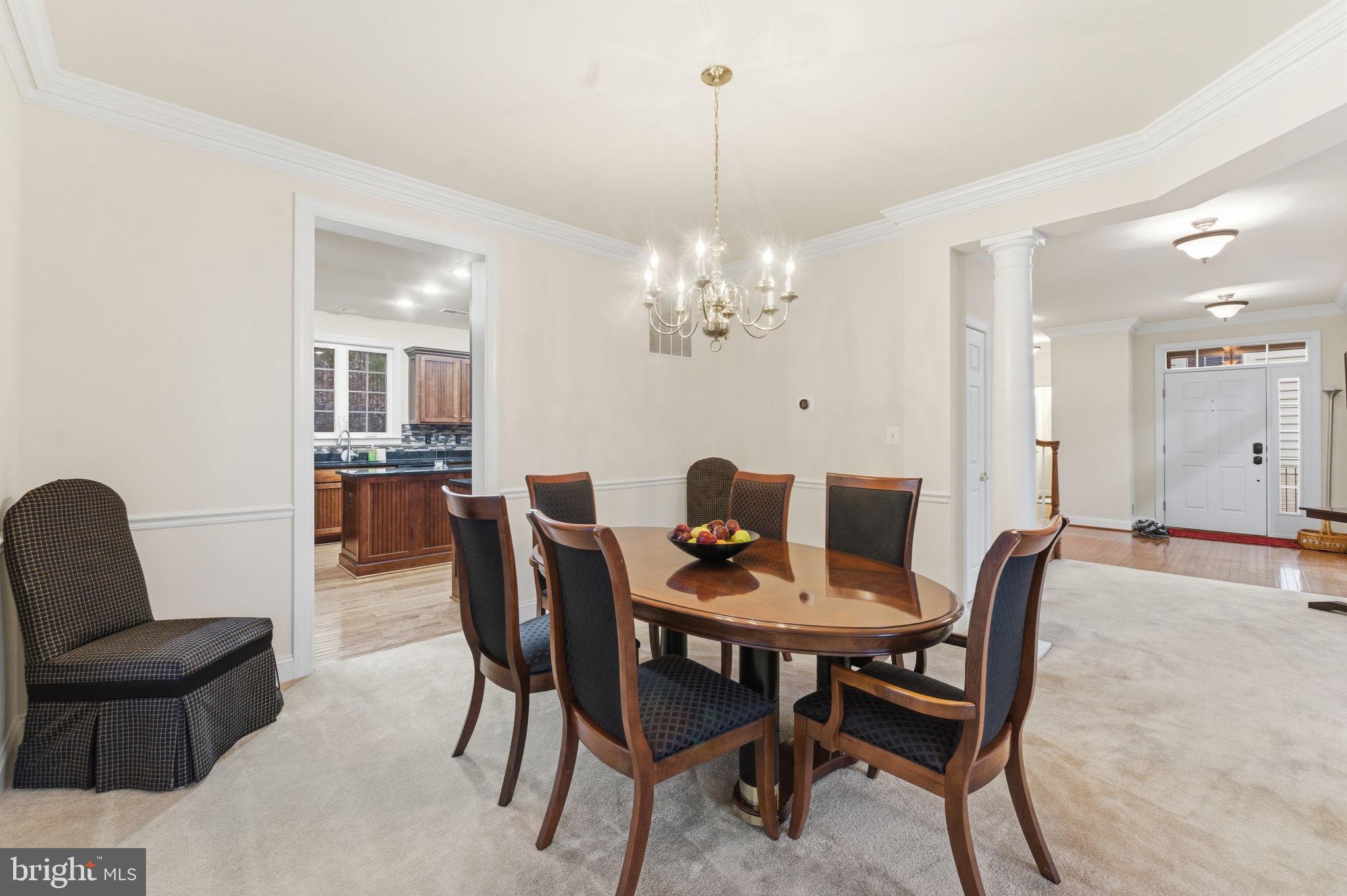 7669 Oak Field Court Springfield, VA 22153 - Photo 13 of 57 a view of a dining room with furniture and chandelier