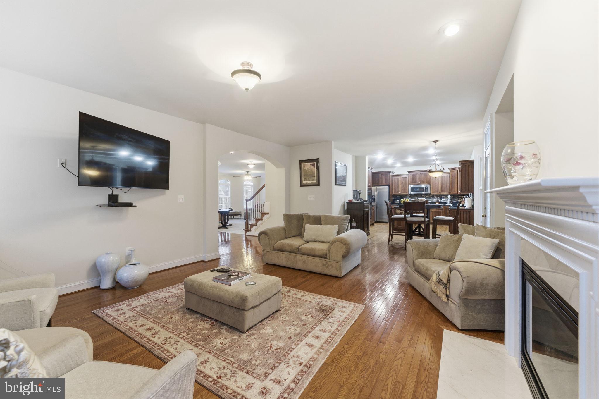 7669 Oak Field Court Springfield, VA 22153 - Photo 15 of 57 a living room with furniture and a flat screen tv