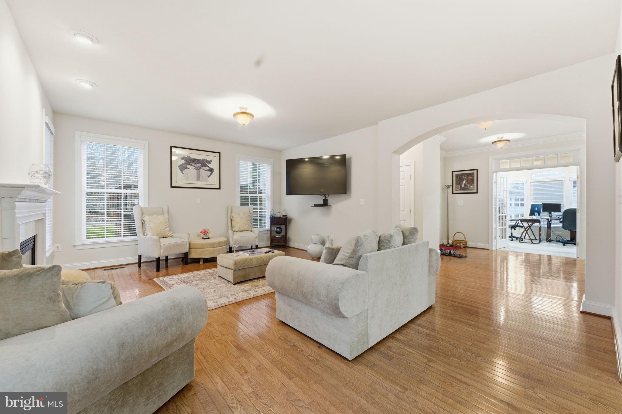 7669 Oak Field Court Springfield, VA 22153 - Photo 16 of 57 a living room with furniture and a flat screen tv