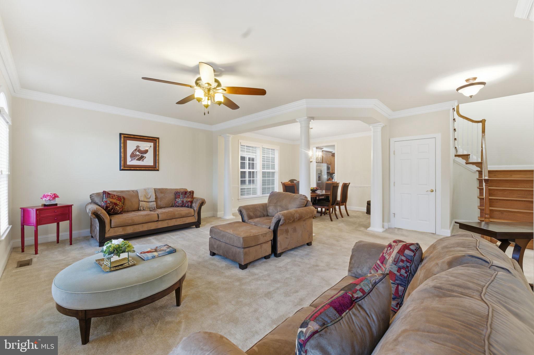7669 Oak Field Court Springfield, VA 22153 - Photo 19 of 57 a living room with furniture and a chandelier