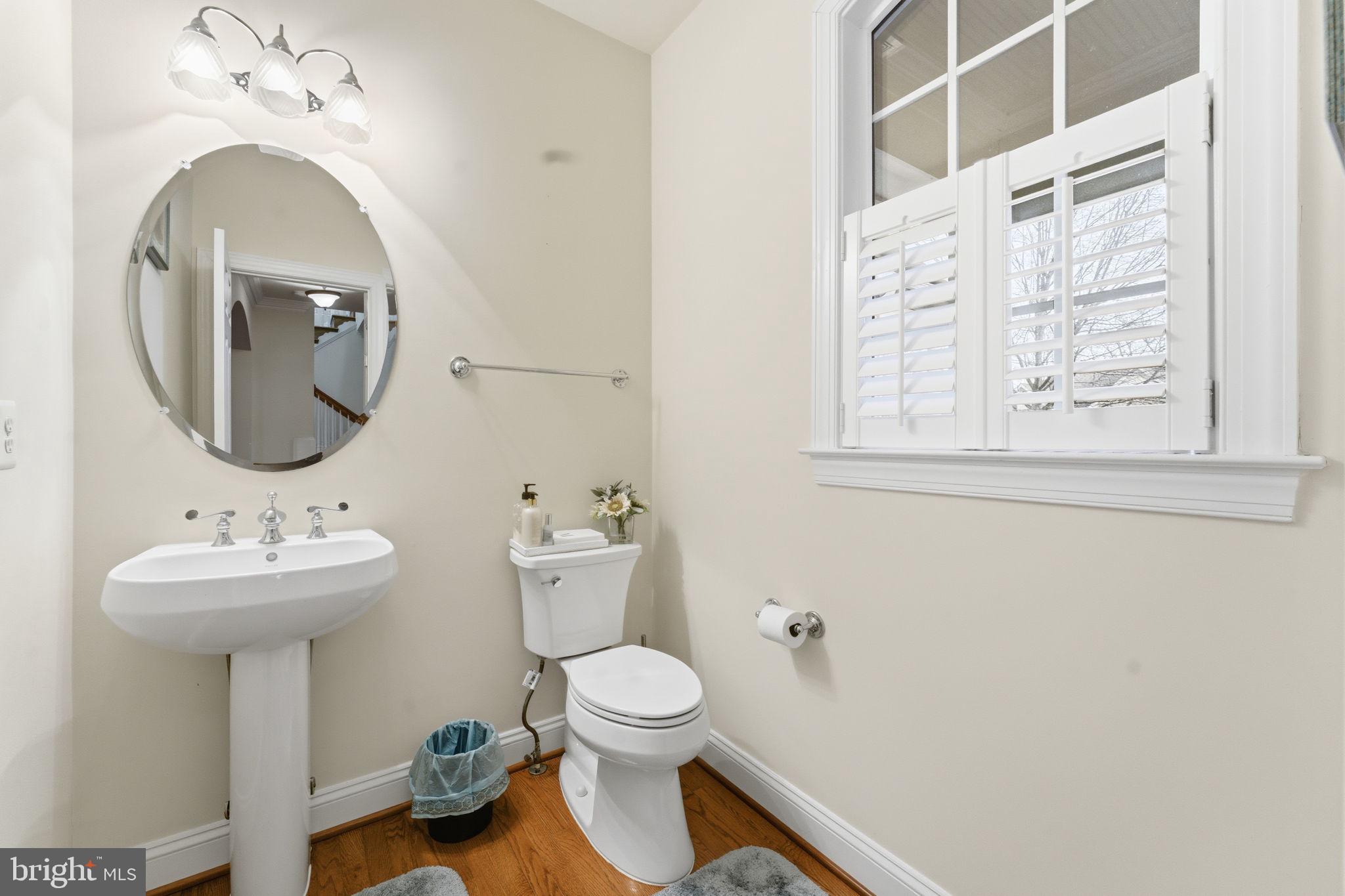 7669 Oak Field Court Springfield, VA 22153 - Photo 24 of 57 a bathroom with a toilet sink and mirror